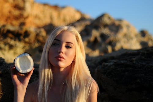 Pretty Woman Holding a Coconut