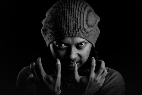 Free Grayscale portrait of a man wearing a beanie, striking a fierce pose. Stock Photo