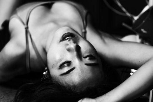 Artistic black and white portrait of a woman with eyes closed, offering a serene and mysterious vibe.