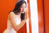 Woman Leaning on an Orange Wall