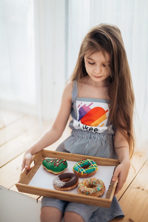 Free Photo of a Girl Holding a Tray with Donuts Stock Photo