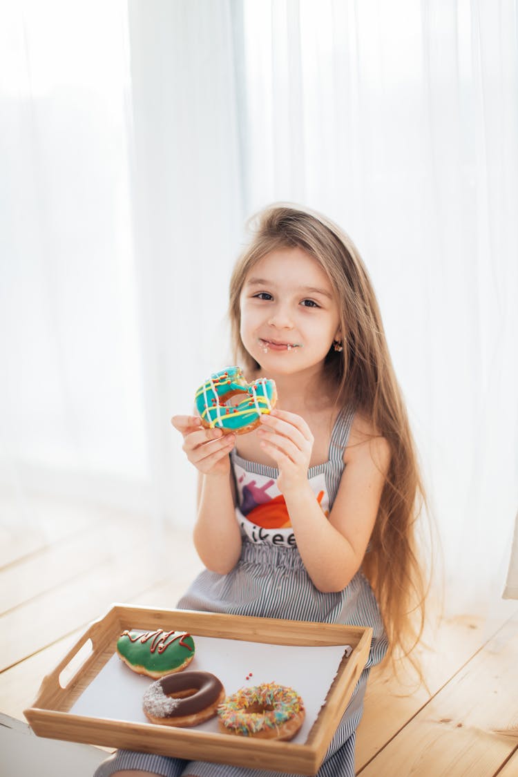 Happy Girl Eating Doughnuts 