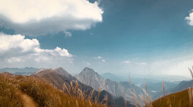 Breathtaking view of mountains under a vibrant blue sky with fluffy clouds and grass foreground.