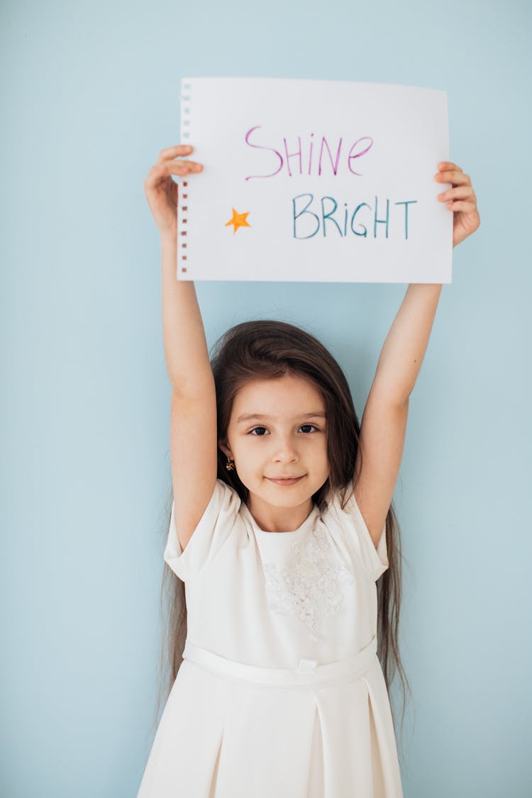 Photo Of A Girl Holding A Piece Of Paper With Text