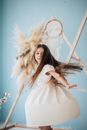 Photo of a Girl in a White Dress Twirling