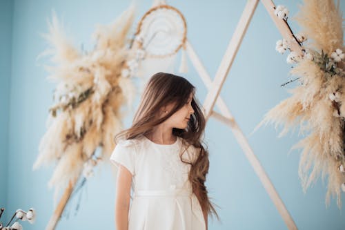 Photo of a Girl with Brown Hair Wearing a White Dress