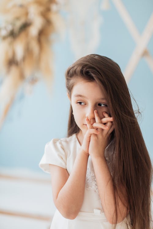Free Portrait of a Child with Her Hands Together Stock Photo
