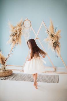 Little Girl Twirling in a White Dress