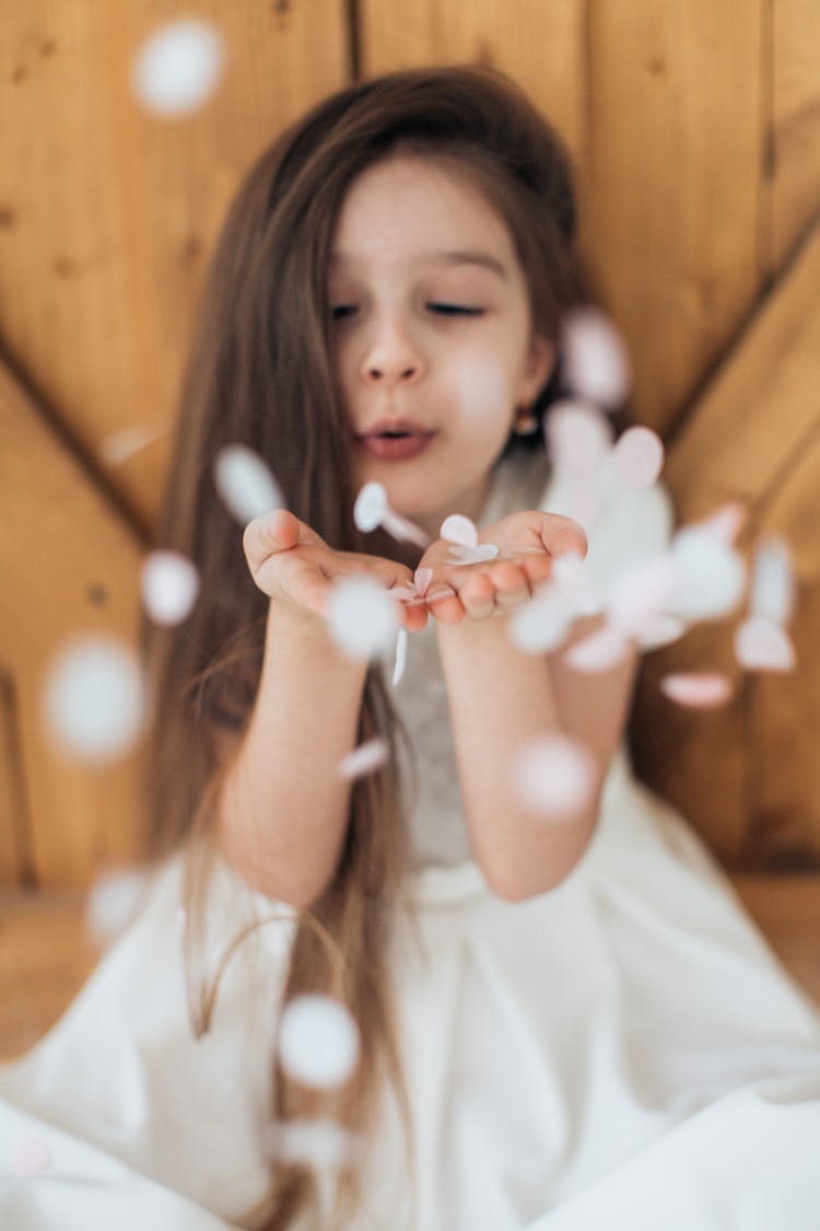 Brunette Girl Blowing Confetti 