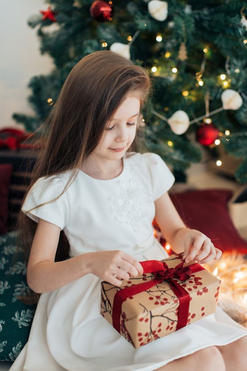 Free Girl Opening A Christmas Gift  Stock Photo
