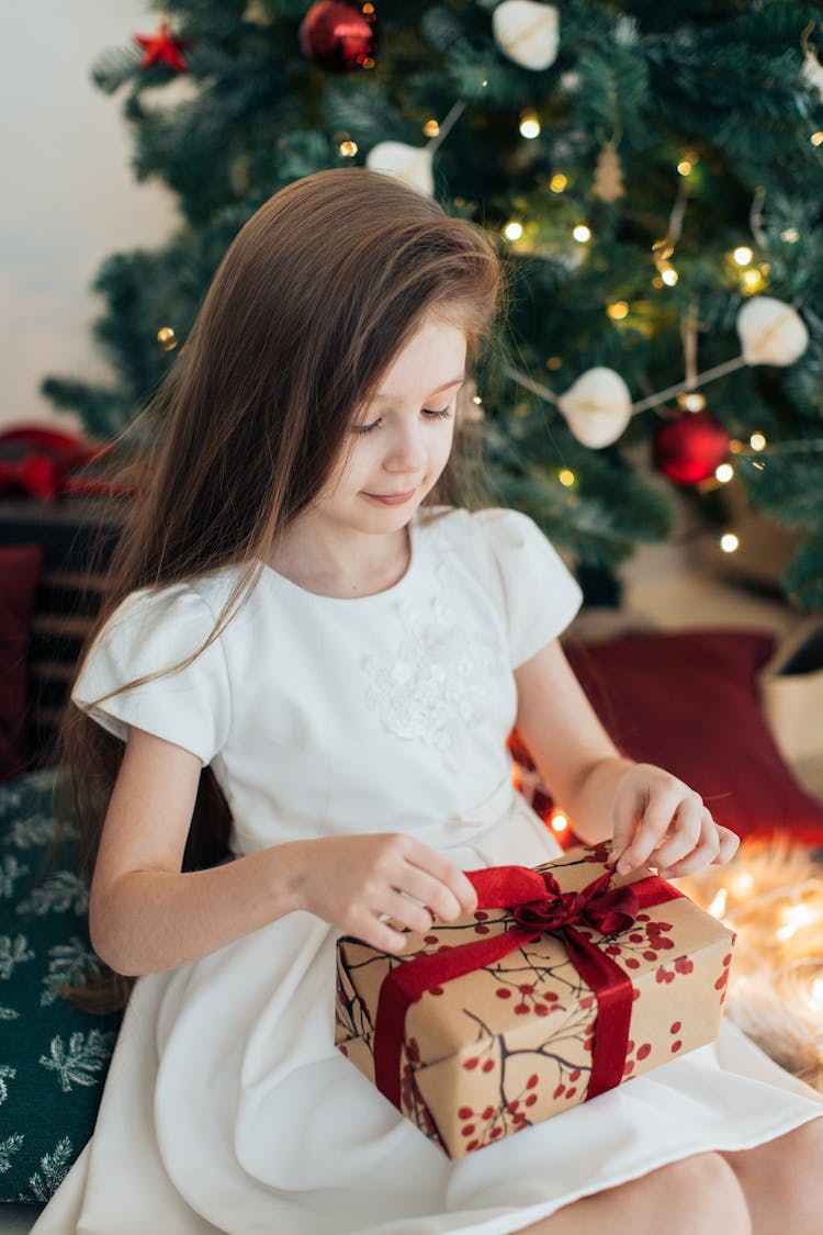 Girl Opening A Christmas Gift 