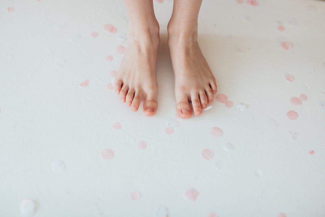 Free Persons Feet on Pink Surface Stock Photo