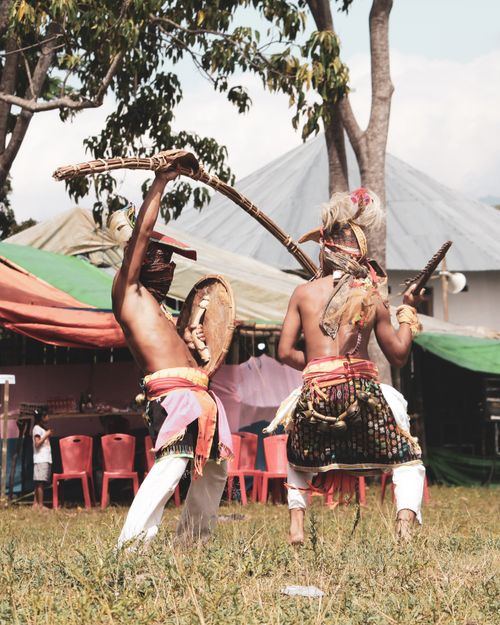 Free Vibrant depiction of men performing a traditional tribal dance in Indonesia. Stock Photo