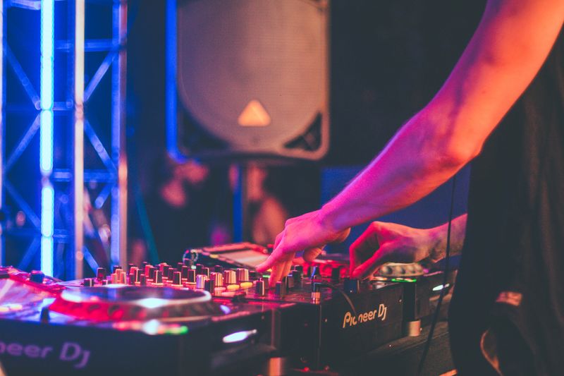 DJ mixing tracks on a console in a Tokyo nightclub