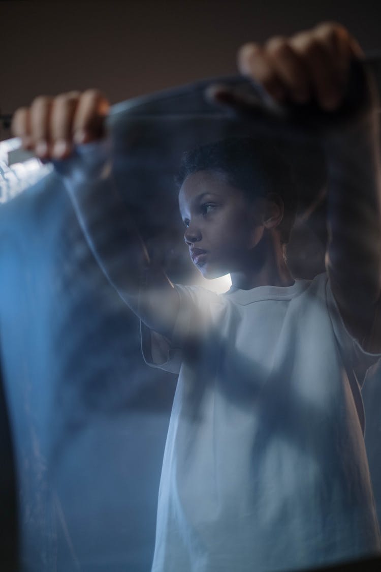 Woman Standing Behind Transparent Fabric