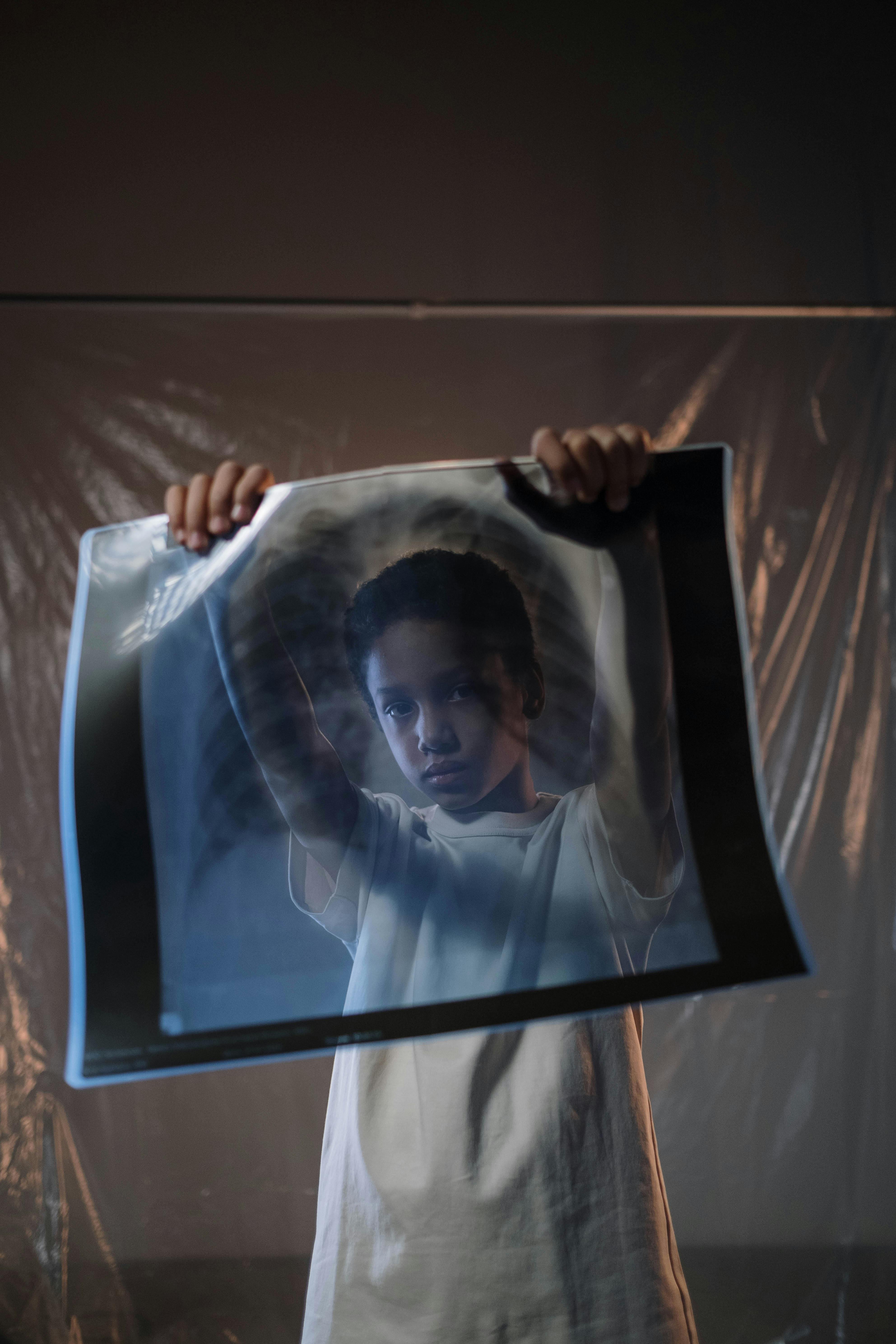 child holding a x ray film