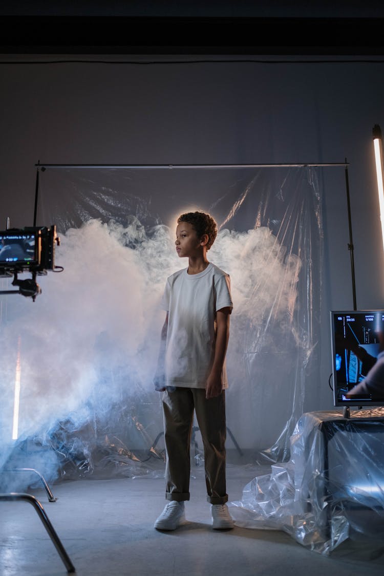 A Boy Standing On A Smoke Near Screen