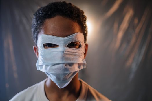 Close-up portrait of a child wearing a creatively modified face mask indoors, conveying safety and creativity.