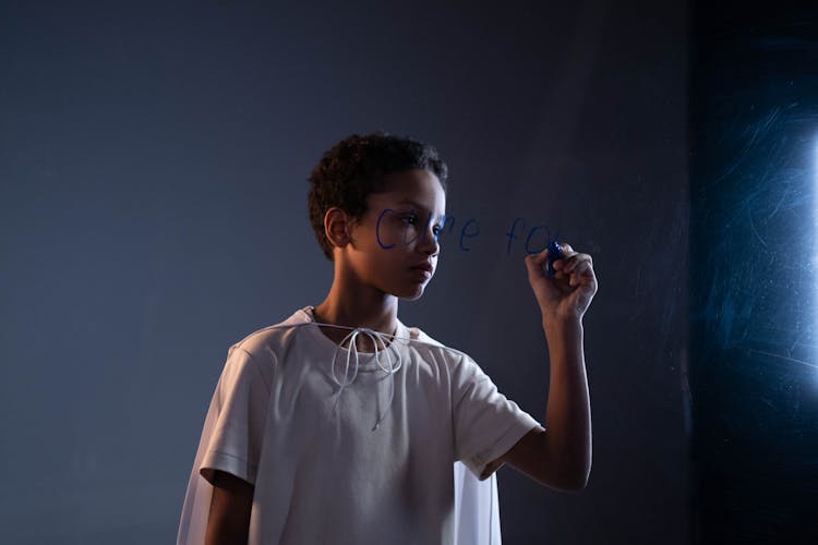 Boy Writing On Glass