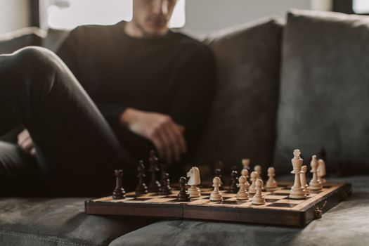 Man in Black Crew Neck T-shirt Playing Chess