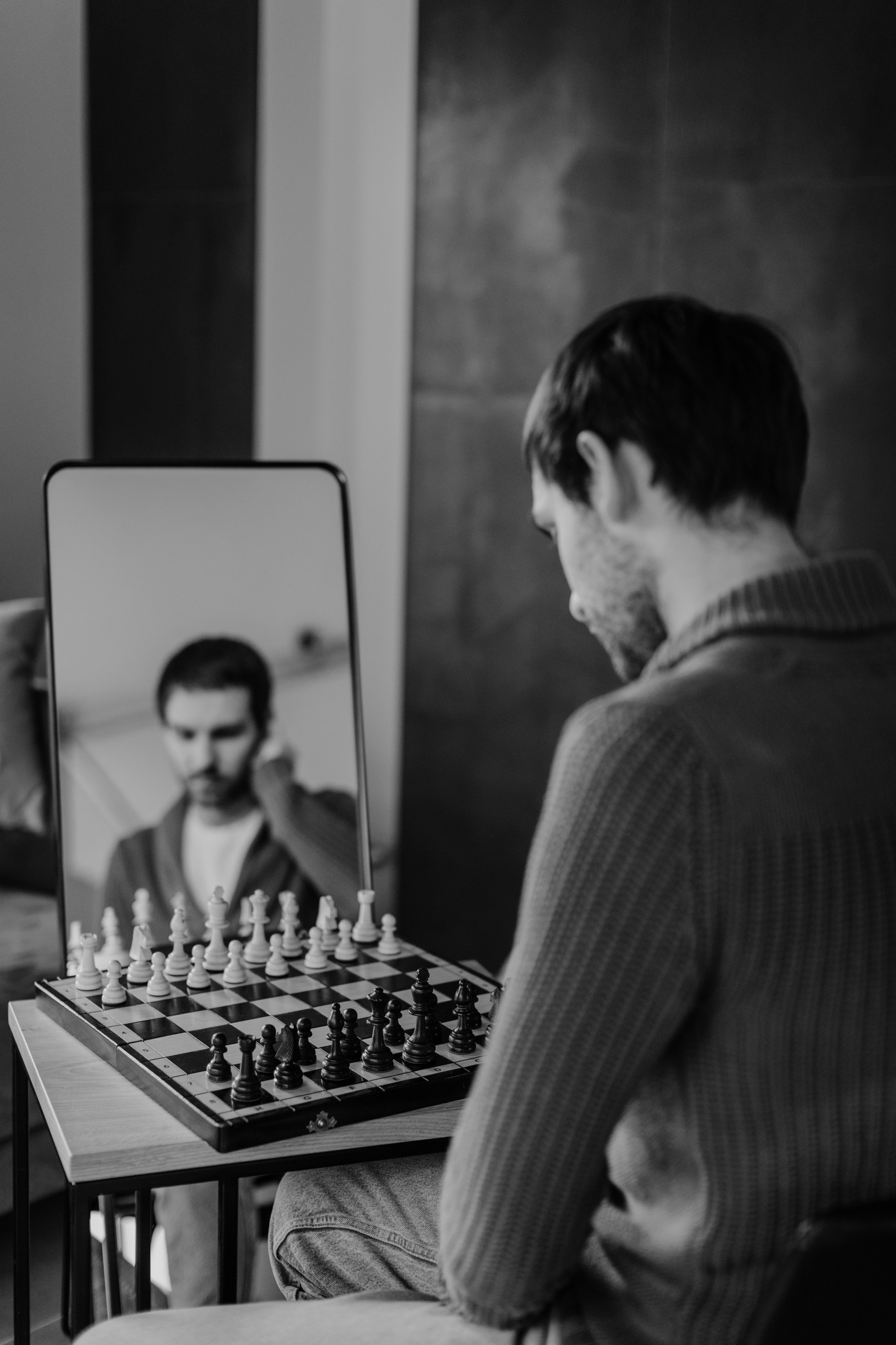 Grayscale Photo of Person Holding Chess Piece · Free Stock Photo