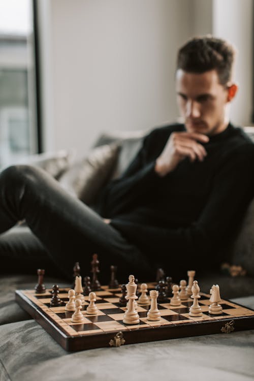 Man in Black Sweater Sitting on Couch