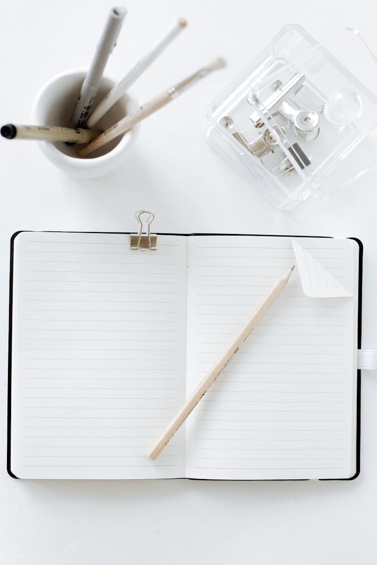 White Notebook And White Pencil