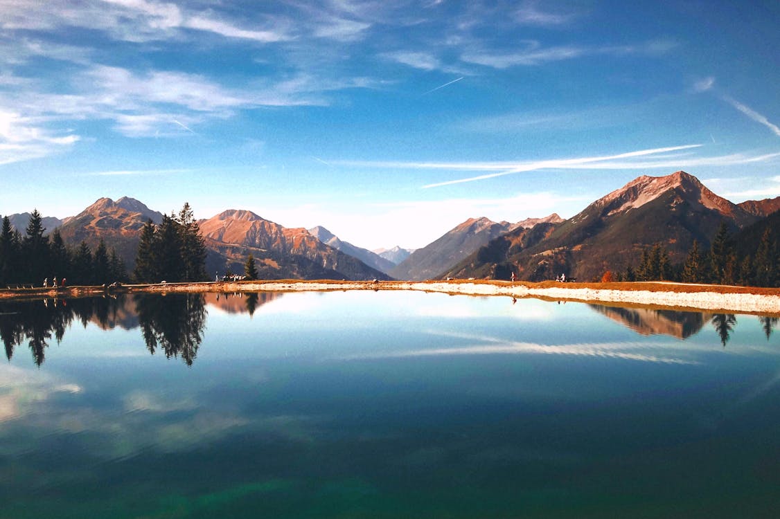 Free Landscape Photography of Brown Mountains Surrounding Lake Stock Photo