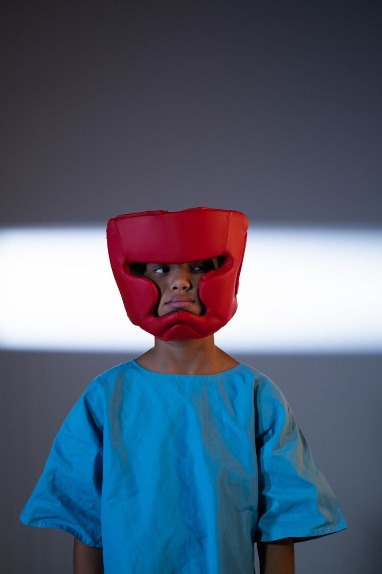 Child Wearing A Boxing Headgear