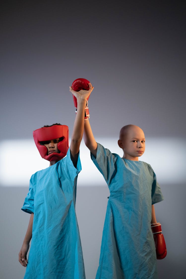 Boys In Robes And With Arms Raised In Boxing Helmet And Gloves