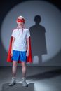Man in White and Red Long Sleeve Shirt and Blue Shorts Standing