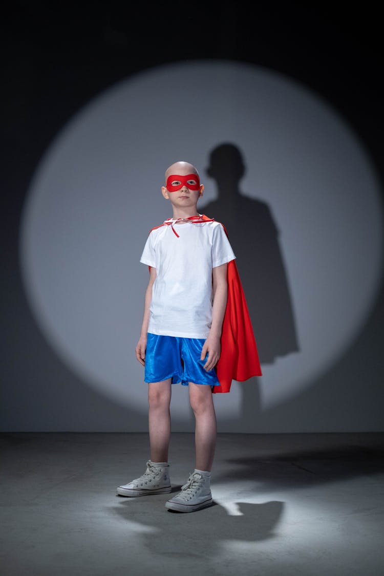 Child Wearing Red Mask And Cape