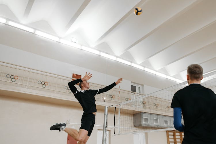 Volleyball Player In Black Shirt Spiking A Ball