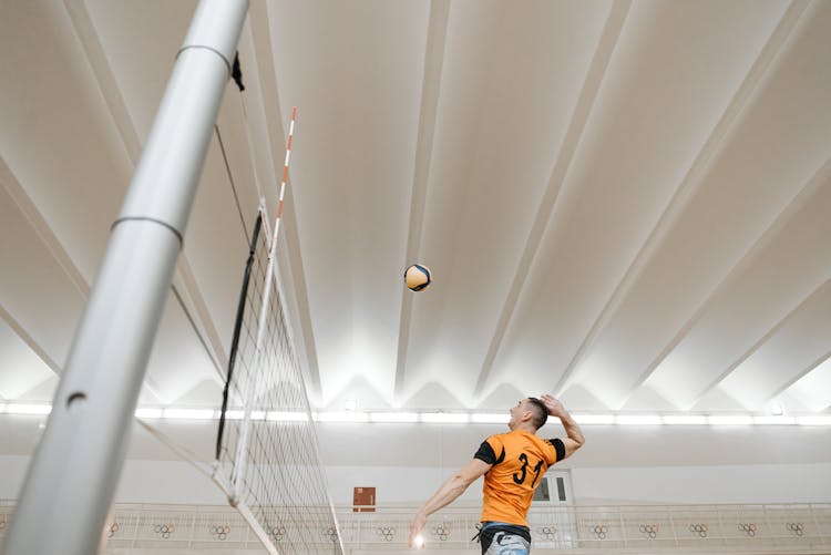 Volleyball Player Spiking A Ball Over The Net