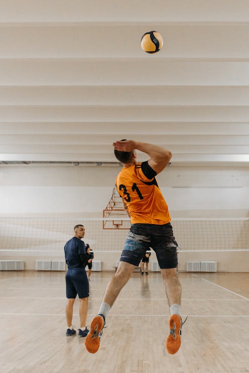 Man Wearing Yellow Jersey Playing Volleyball
