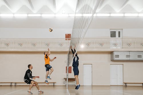 Free Men Playing Volleyball Inside a Building Stock Photo