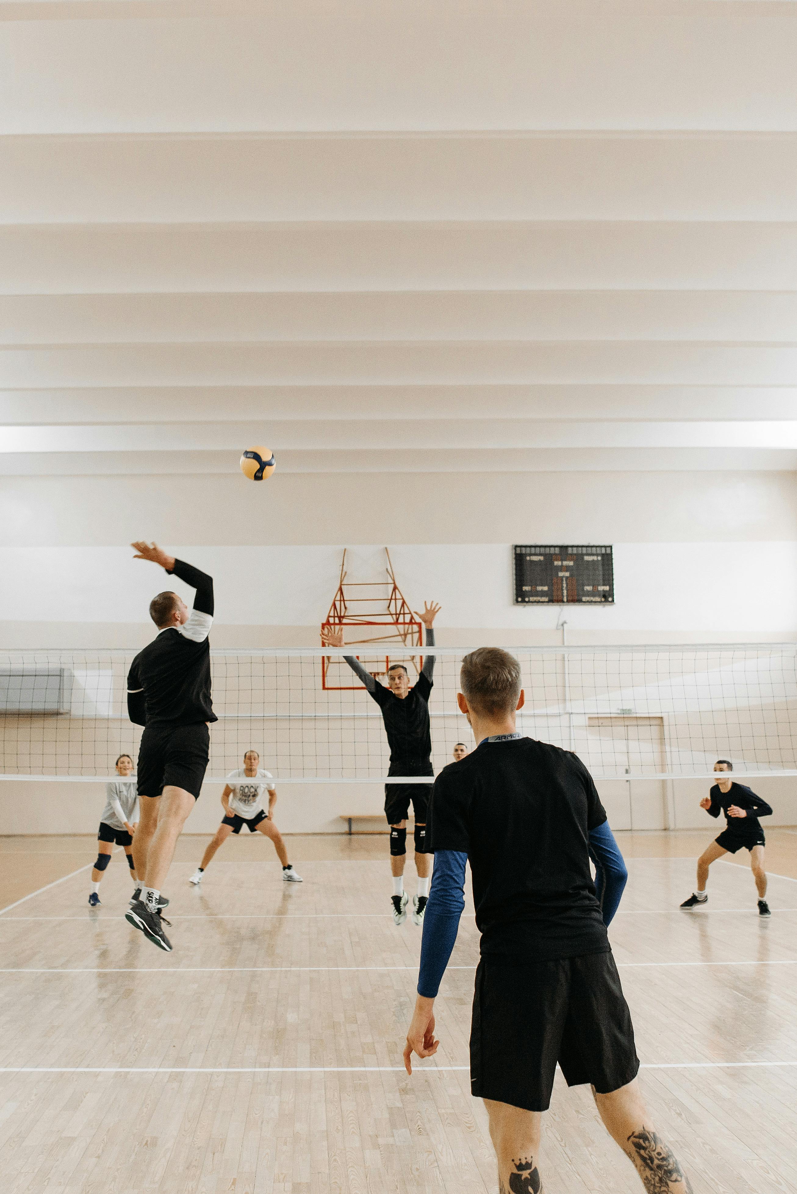 man in black t shirt playing volleyball