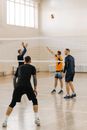 Man in Black T-shirt and Blue Shorts Playing Basketball