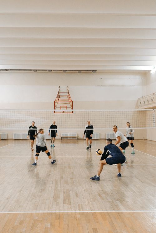 Free Energetic players engaged in a competitive indoor volleyball game. Stock Photo