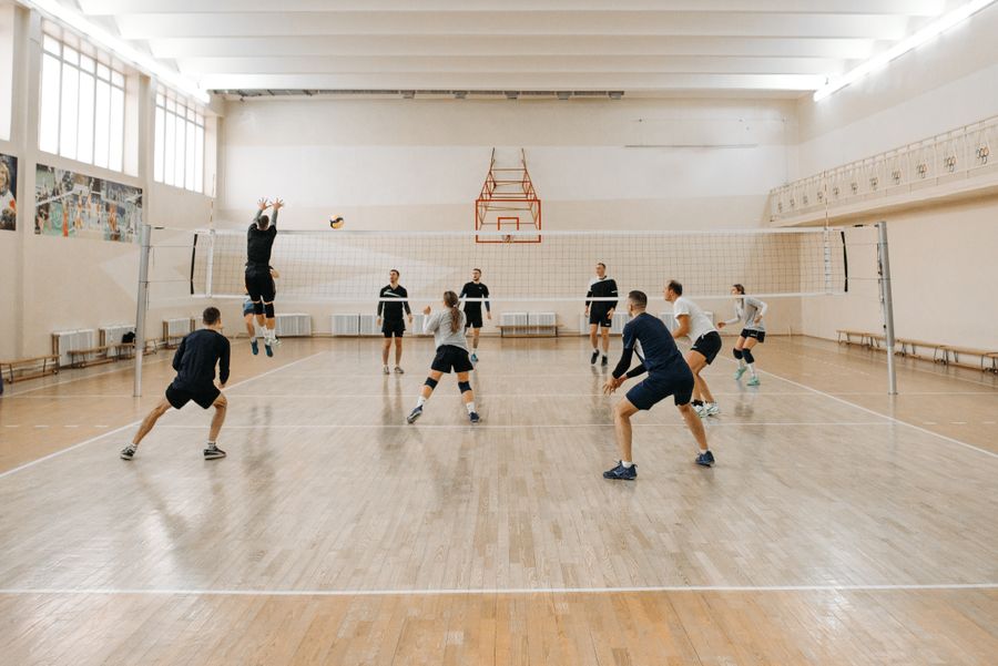 Partido de voleibol sobre cancha interior de madera