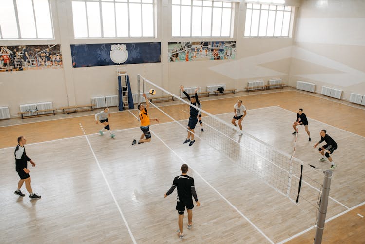 Photo Of Men And Women Playing Volleyball