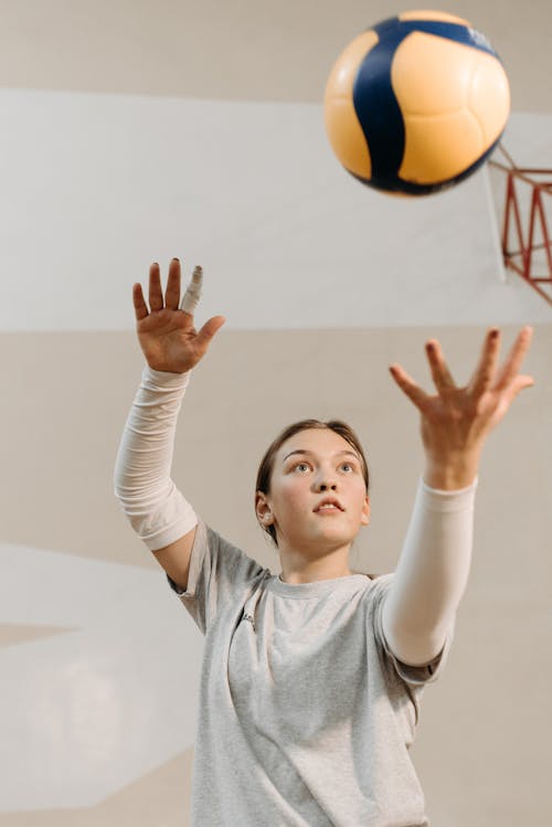 Woman in Gray Shirt Playing Volleyball