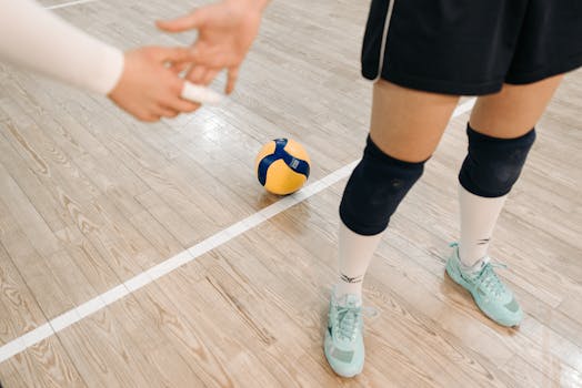 Close-up of volleyball players ready for action on an indoor court.