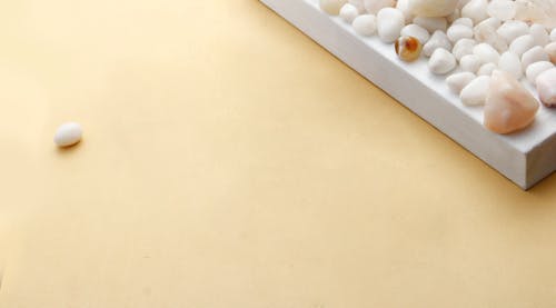 Pebbles on White Wooden Surface 