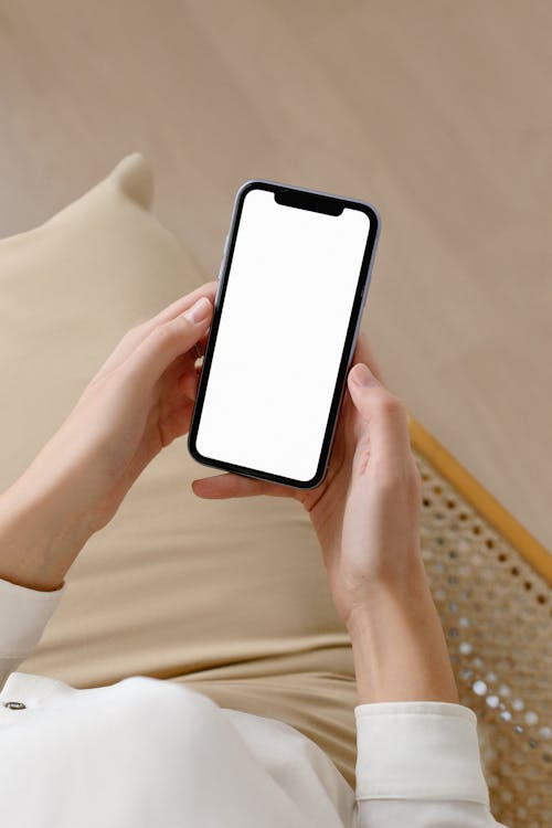 Free Mockup with Woman Holding Phone Stock Photo