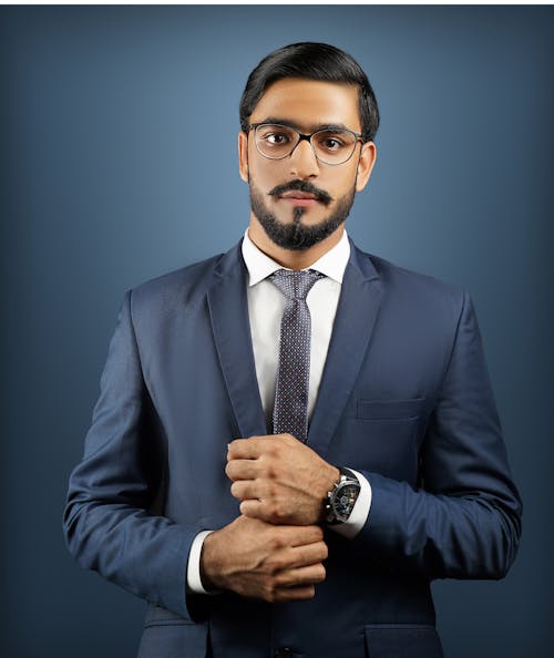 Photo of a Man with Eyeglasses Wearing a Blue Suit