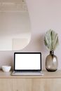 Laptop Beside Clear Glass Vase