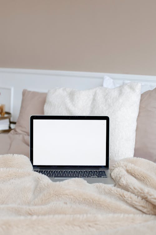 Free Photograph of a Laptop on the Bed Stock Photo