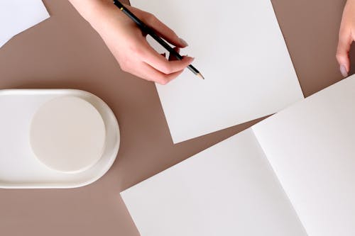 Free Person Writing on White Paper Stock Photo
