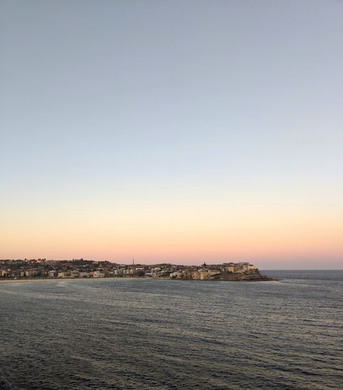 Free A beautiful sunset view over Bondi Beach, capturing the serene coastline and tranquil sea. Stock Photo